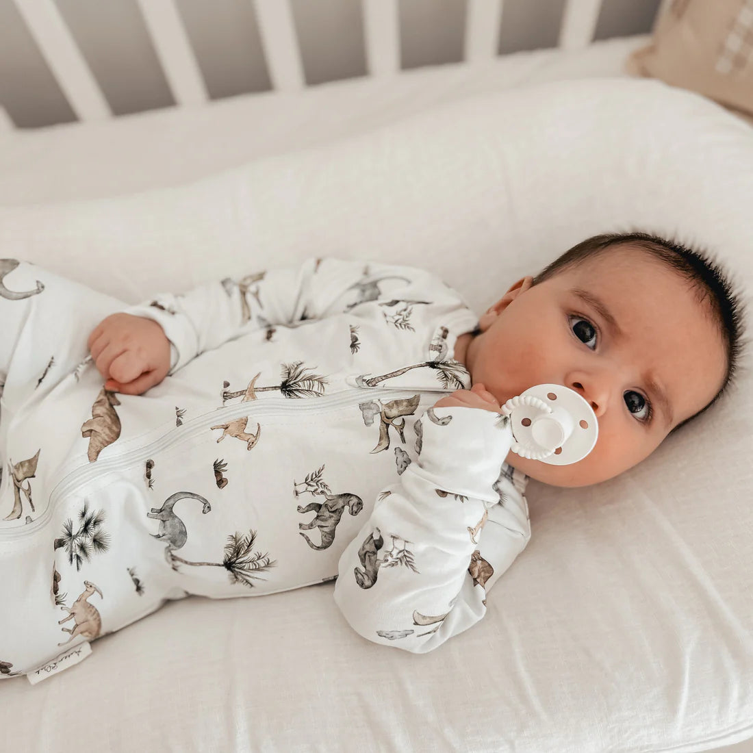 Baby romper in a delightful Dino design. Zip romper dinosaur's and palm trees on the softest sage green. Organic cotton perfect for baby's delicate skin.