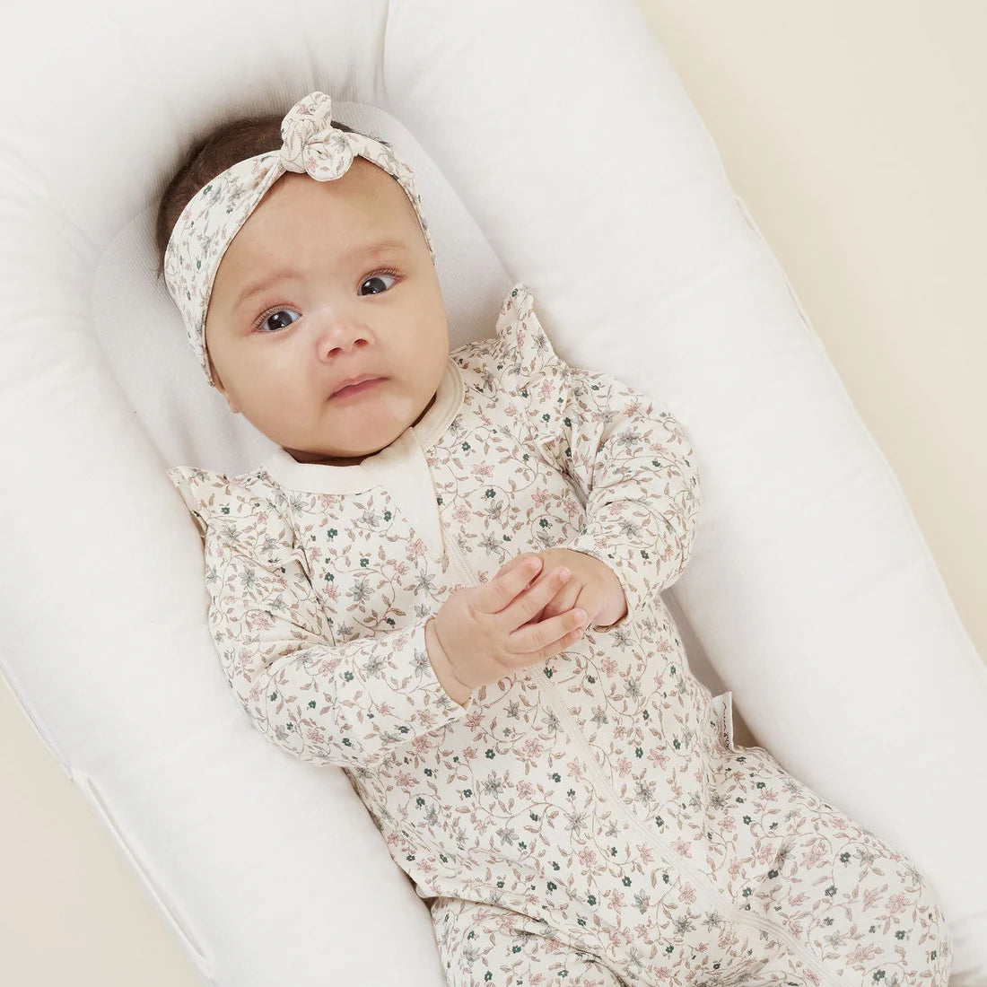 Baby zip romper in soft organic cotton. Delicate design wnter floral pretty tiny dusty pink and blue flowers.