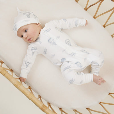 Baby Zip romper in soft organic cotton. Gorgeous design of blue planes and hot air balloons on a white background.