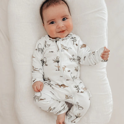 Baby romper in a delightful Dino design. Zip romper dinosaur's  and palm trees on the softest sage green. Organic cotton perfect for baby's delicate skin. 